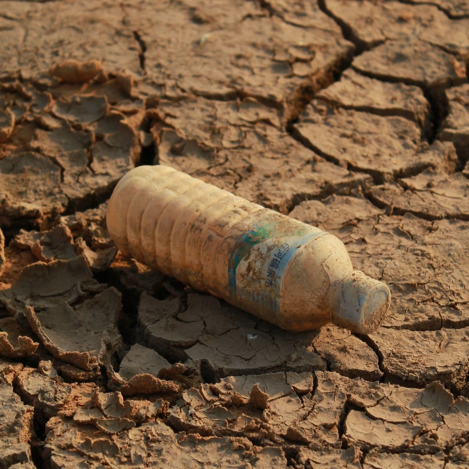 White plastic bottle on brown soil.
Photo by Bram Wouters (@bram_wouters) on Unsplash. | WaterHub - Quota-based Water Refill Stations in Indonesia